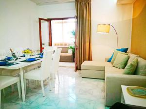 a living room with a table and a couch at Acquamarina Apartment with Terrace in Marsala