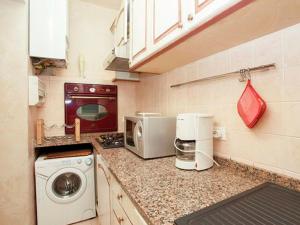 a kitchen with a washer and a microwave at Picturesque Apartment in Florence Town Centre in Florence