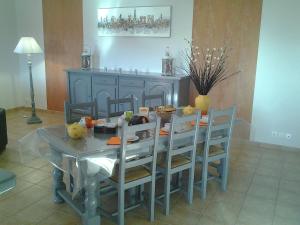 a dining room with a table and chairs and a table and chairsktop at Cozy Villa in Saint Victor de Malcap with Swimming Pool in Saint-Victor-de-Malcap