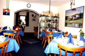 a restaurant with tables and chairs in a room at Haus Stefanie in Inzell