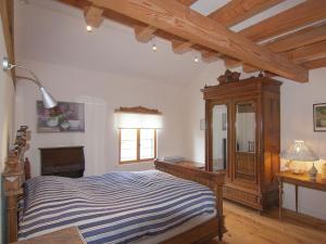 a bedroom with a bed and a dresser and a window at Spacious cottage in Roussines with heated pool in Roussines