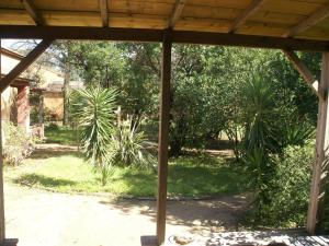 a view of a garden from the porch of a house at Beautiful holiday home near the beach in Santa-Lucia-di-Moriani