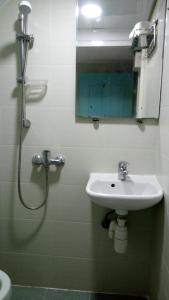 a bathroom with a sink and a shower with a mirror at Pearl Guesthouse - 6/F in Hong Kong