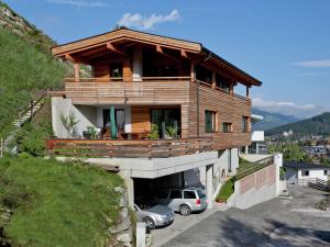 a house on a hill with a car parked in front at Apartment with terrace in Kaprun Salzburg in Kaprun