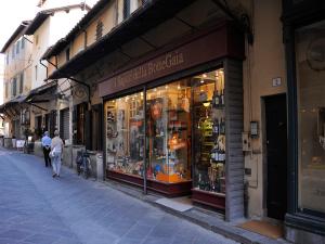a man walking past a store window on a street at Appartamento il Battistero in Pistoia
