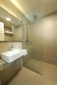 a bathroom with a sink and a glass shower at Perhentian Island Resort in Perhentian Island