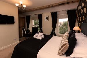 a bedroom with a large bed with towels on it at Langdale View Guest House in Bowness-on-Windermere