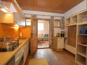 a kitchen with an open door to a dining room at Beautiful Apartment in Altenmarkt im Pongau with Garden in Altenmarkt im Pongau