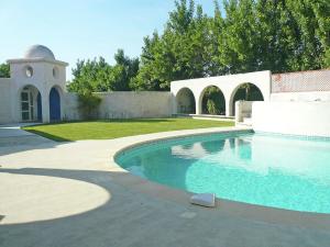 a swimming pool in a yard with a building at Holiday home with private pool in Villedaigne