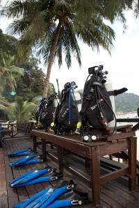 a group of kayaks and backpacks sitting on a table at Perhentian Island Resort in Perhentian Islands