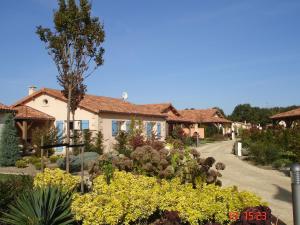 a garden in front of a house with flowers at Luxe villa in Les Forges with BBQ Garden in Les Forges