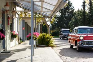an old red car parked on the side of a street at Wittrup Motel in Albertslund