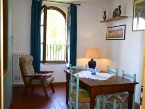 a dining room with a table and a chair and a window at Nice apartment in the area of Vinci in Vinci