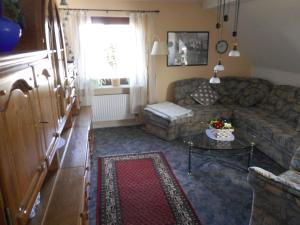 a living room with a couch and a table at Apartment in Langewiese Sauerland with garden in Winterberg