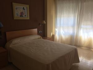Postel nebo postele na pokoji v ubytování Hostal Meseguer
