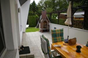 a table and chairs on a balcony with a patio at Ferienhaus Krüger in Loissin