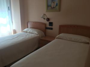 Postel nebo postele na pokoji v ubytování Hostal Meseguer