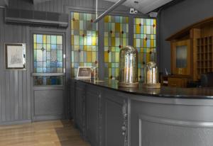 a bar in a room with stained glass windows at Mesón Castilla Atiram Hotels in Barcelona