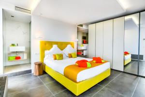 a bedroom with a bed with colorful pillows on it at Cosmo Apartments Sants in Barcelona
