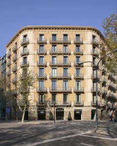 a large yellow building on a city street at H10 Casanova in Barcelona