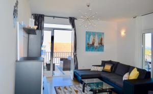 a living room with a couch and a glass table at Indigo Cavtat Apartments in Cavtat