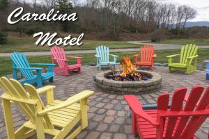 a group of colorful chairs around a fire pit at Carolina Motel in Franklin