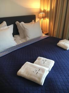 a hotel room with a bed with towels on it at Baltic Sands in Hel