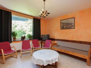 a living room with chairs and a table and a window at Spacious holiday home with roofed terrace in La Gleize