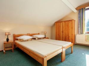 a bedroom with a large bed in a room at Spacious holiday home with roofed terrace in La Gleize