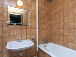 a bathroom with a sink and a bath tub at Spacious holiday home with roofed terrace in La Gleize +29 photos