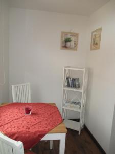 a dining room with a table and a book shelf at Ferienhaus Mack in Wernigerode