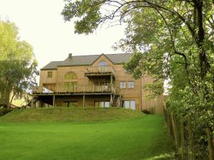 a large house on top of a grass field at Fort like Holiday Home in Sart Bertrix a drive away from Luxembourg in Sart