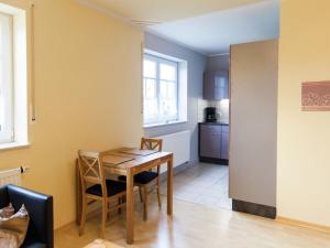 a kitchen and dining room with a table and chairs at Apartment in Rommersheim with countryside view in Prüm
