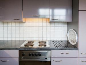 a kitchen with a stove and a counter top at Apartment in Rommersheim with countryside view in Prüm