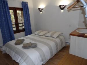 a bedroom with a large bed and a sink at Le Relais de l'Artuby in Séranon