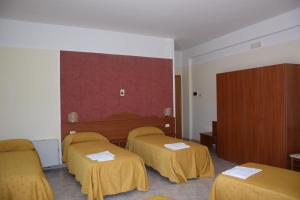 Postel nebo postele na pokoji v ubytování Hotel Dei Cappuccini