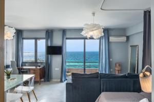 a living room with a couch and a view of the ocean at Nais Apartments & Studios in Chania