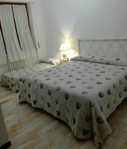 a bedroom with two beds and a table with a lamp at Casa Dilva in Porto SantʼElpidio