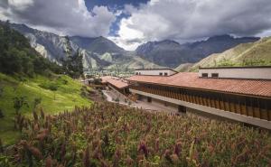 a view of a building with mountains in the background at Explora Valle Sagrado in Urubamba