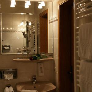a bathroom with a sink and a mirror at Bengel's Hotel zur Krone in Mülheim-Kärlich +42 photos