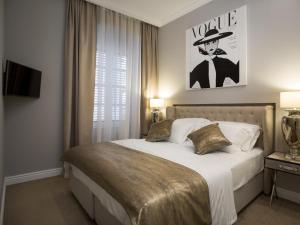 Postel nebo postele na pokoji v ubytování Tailor Two-Bedroom Suite + 20 fotografií