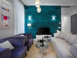 a living room with a couch and a tv at Tailor Two-Bedroom Suite in Dubrovnik