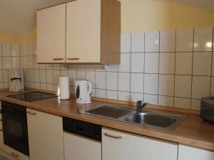 a kitchen with a sink and a counter top at Comfy Apartment in Wei ig with Garden in Weißig
