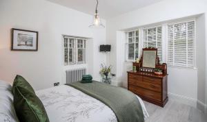 A bed or beds in a room at Firlands Lodge