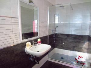 a bathroom with a sink and a shower at Sleep And Fly Rome Airport in Fiumicino