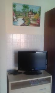 a flat screen tv sitting on top of a cabinet at La Cornice del Garda in Cavalcaselle