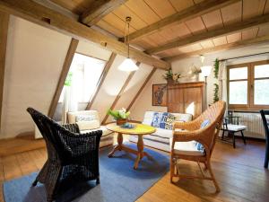 a living room with a couch and a table and chairs at Cosy holiday home with gazebo in Weißenburg in Bayern