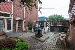 a backyard with a grill on a wooden deck at A Tanners Home Inn Bed and Breakfast in Saint John