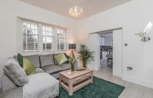 a living room with a couch and a table at Firlands Lodge in Forres