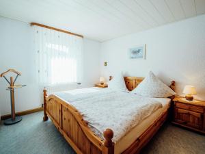 a bedroom with a wooden bed and a window at Apartment near the forest in Plankenstein in Plankenfels